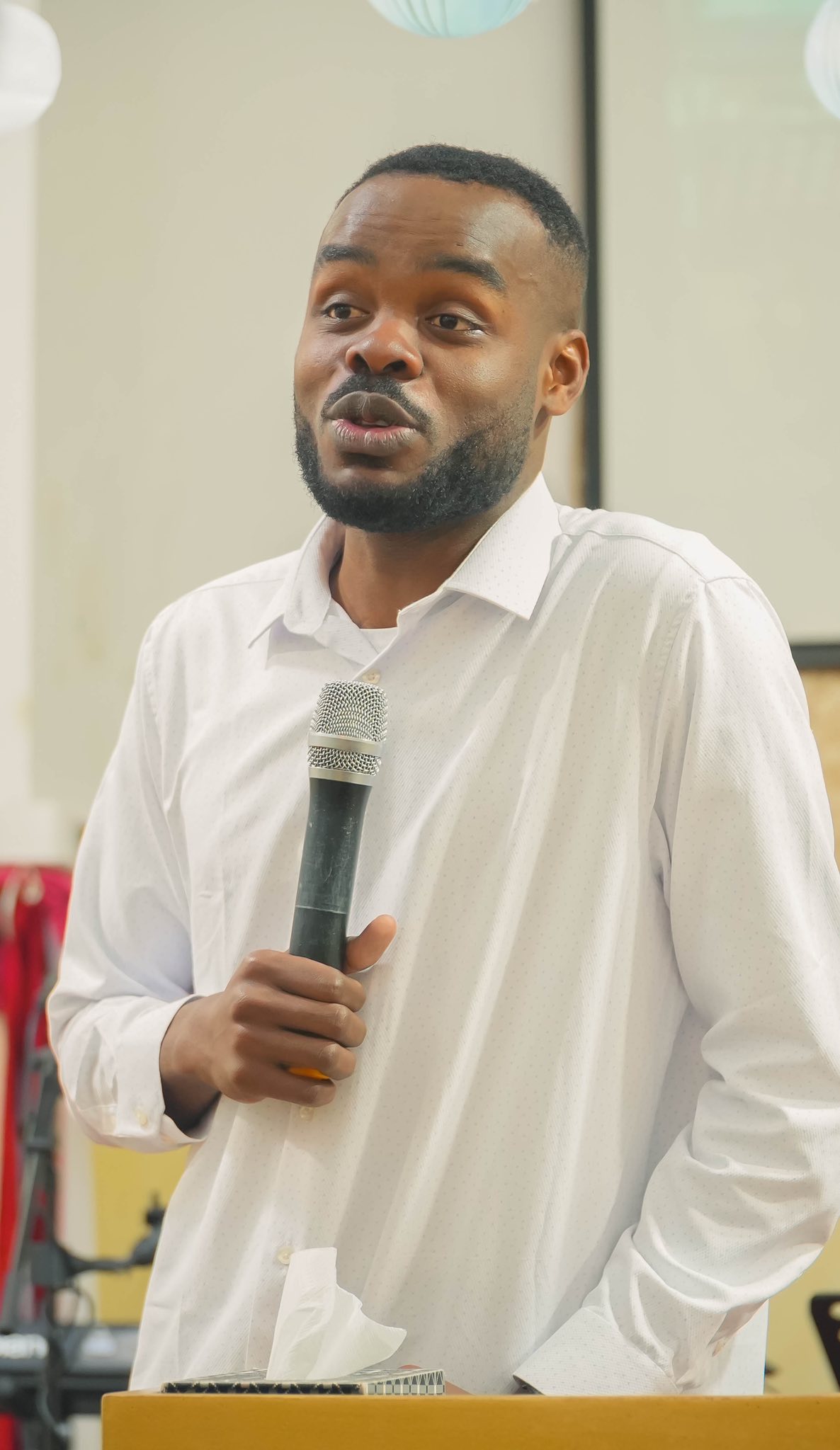 Samuel Kobina Gyasi speaking into a microphone